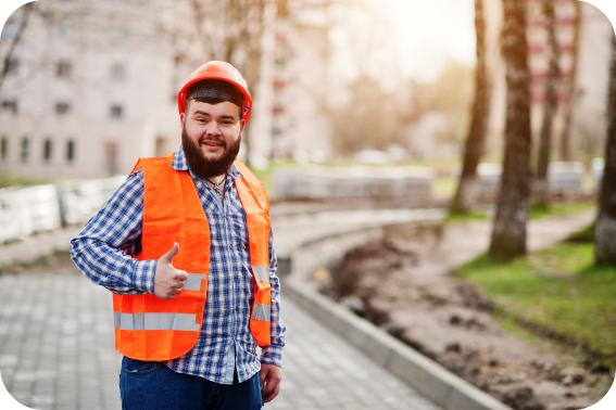 Beard man showing thumb wearing orange construction suit and helmet.